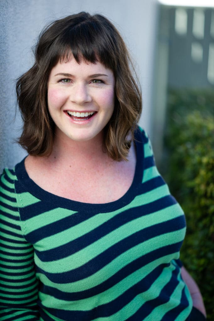 acting headshot pose of a female actress smiling with a natural laugh